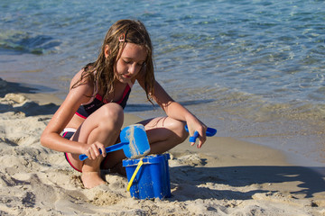 Young girl playing in the sand
