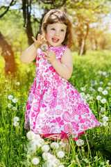 child girl at dandelion meadow in summer