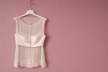 Transparent blouse is on lilac background.