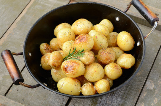 Whole fried young potato with rosemary