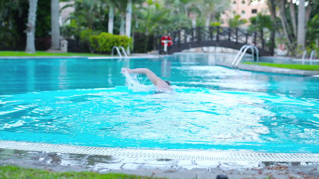 Young man starting swim in the swimming-pool