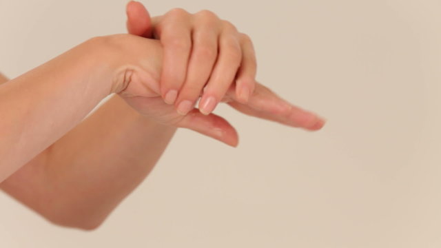 Woman using moisturizing cream for hands