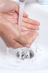 Fototapeta premium Woman hands under a waterjet