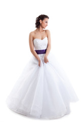 Fototapeta na wymiar Cute girl posing in wedding gown isolated on white