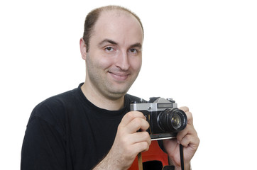 young man holding a vintage camera on white background