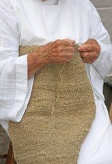 hands of an elderly woman during the processing of wool sweater