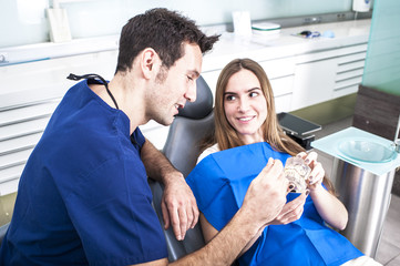 Dentist showing a client something about dental treatament