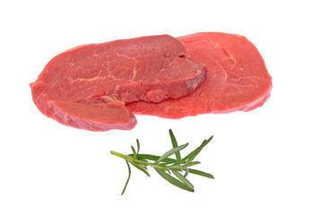 raw beef steaks with rosemary herb isolated on white background