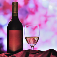 bottle with red wine and glass