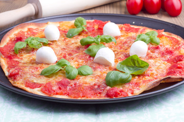 Pizza with mozarella and basil