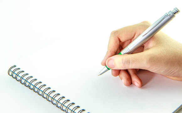 Blank notebook with hand holding a pen