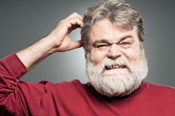 Obraz premium Mature Caucasian Man Scratching His Head Like He Forgot Somethin