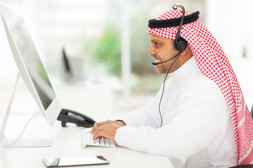 middle eastern businessman working on a computer