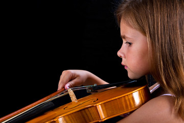 Girl playing violin in pink dress