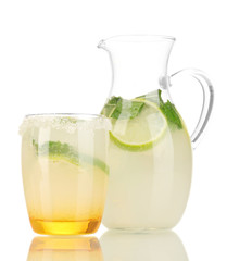 Citrus lemonade in pitcher and glass isolated on white