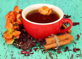 Herbal tea in cup, on color wooden background