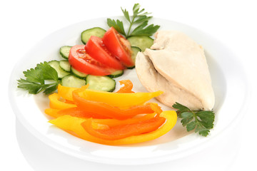 Boiled chicken breast on plate with vegetables close up