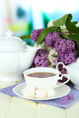 Composition with beautiful lilac flowers, tea service