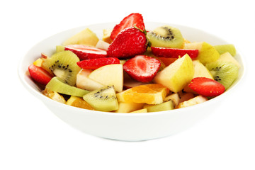 Useful fruit salad of fresh fruits and berries in bowl isolated