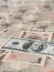 100 US dollar note isolated on Japanese yen note background