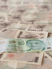 SIngapore dollar note isolated on Japanese yen note background