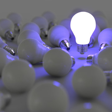 3d growing light bulb standing out from the unlit incandescent b