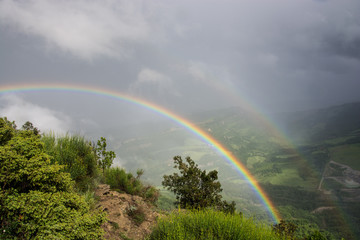 Double rainbow over hills