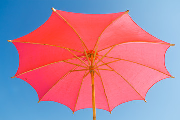 Pink umbrella, made of paper.