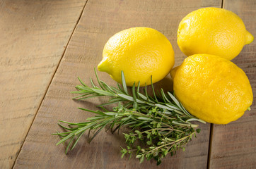 Lemons and herbs on a wooden table