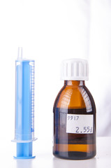 Syringe and sirup isolated on white