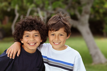 Two smiling happy young mixed race boys outside © Nicholas B