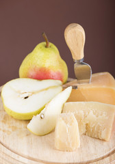 cheese and fruit on a dark background