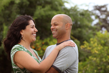 Obraz premium A happy mixed race couple relax outside - with copy space