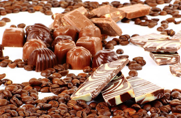 sweet chocolate candies and coffee beans isolated