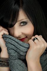 Portrait of a bautiful young woman with red lipstick and grey sc
