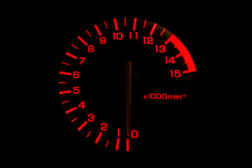 automobile tachometer on black background