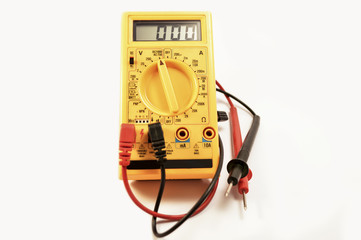 Digital yellow multimeter on a white background