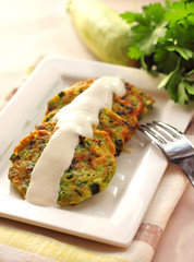 Zucchini pancakes with green onions and sour cream
