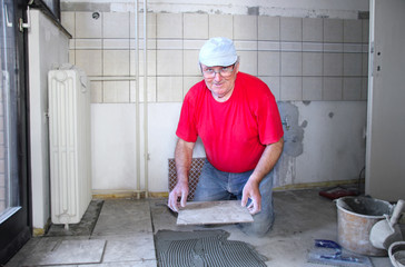 Senior man with ceramics, interior decoration