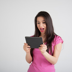 Fototapeta premium beautiful woman is pleased tablet