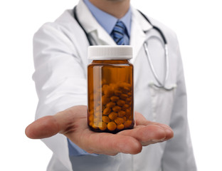 Doctor holding bottle of pills