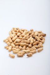 .Dried peanuts in closeup on the white background