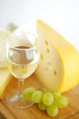 cheese and wine on a wooden table