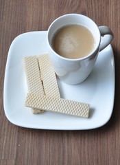 Three wafers and a cup of coffee