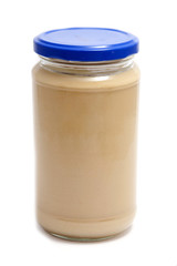Jar of peanut butter on a white background