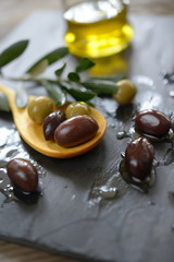 Olives in a wooden spoon