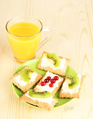 Tasty canapes with cheese and kiwi, cranberry,