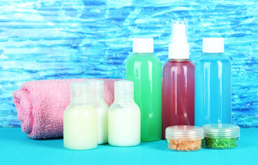 Hotel cosmetics kit on bright color background