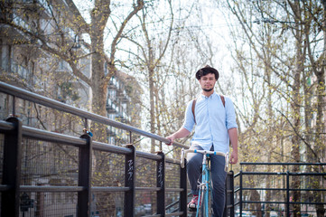 Obraz na płótnie Canvas hipster young man on bike