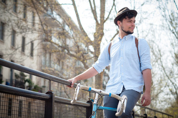 Fototapeta na wymiar hipster young man on bike